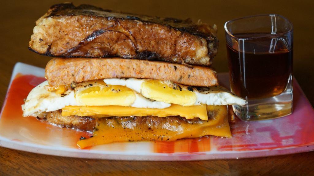 Sausage, Egg, ＆ Cheddar French Toast Sandwich · The breakfast trinity available all day.