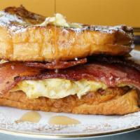 Bacon ＆ Egg French Toast Sandwich · A breakfast favorite two slices of bacon and a fried egg. Served with butter and syrup.
