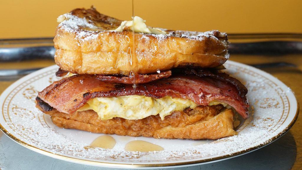 Bacon ＆ Egg French Toast Sandwich · A breakfast favorite two slices of bacon and a fried egg. Served with butter and syrup.