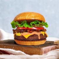The Classic Vegan Burger  · Seasoned vegan burger patty topped with lettuce, tomato, onion, and pickles. served with a s...