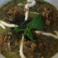 Aash Reshteh · Persian noodle soup with fresh herbs and pinto beans topped with fried onion and whey