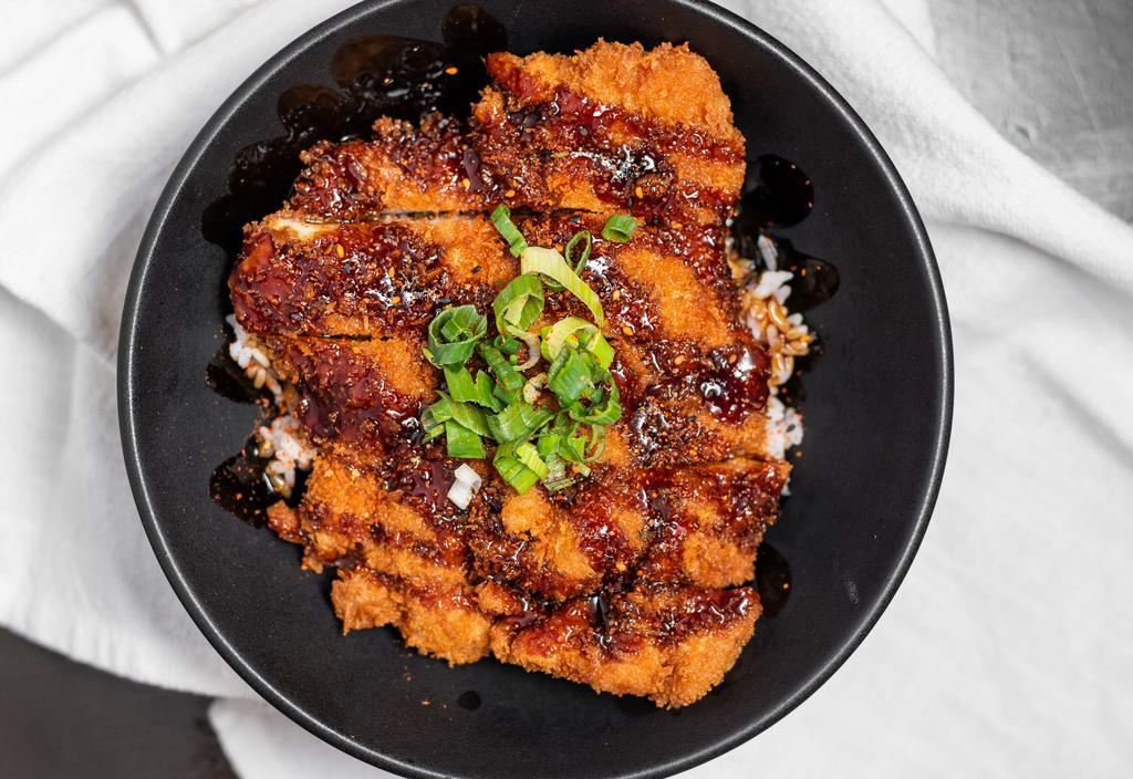 Chicken Katsu Don · Panko breaded fried chicken cutlet over rice and glazed with unagi sauce topped with green onions and shichimi mixed powder.