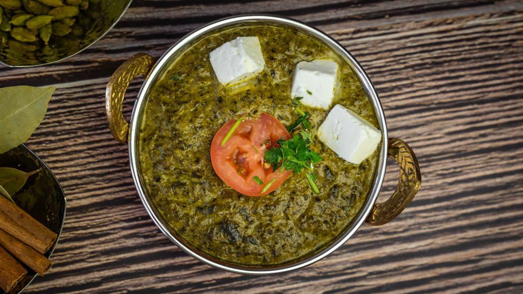 Palak Paneer · Spinach with home made cheese sauce, herbs & spices.