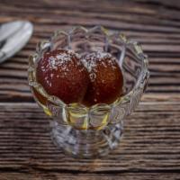 Gulab Jamun · Dumplings of four, dried milk in cardamom flavored syrup.