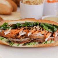 Porchetta Bánh Mì · Slow roasted pork belly, crispy fried onions, sweet pickled carrots & daikons, cucumbers, ci...