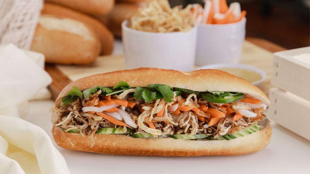 Shredded Chicken Bánh Mì · Baguette Bánh Mì Gà: Shredded light and dark meat chicken, crispy fried onions, sweet pickled carrots & daikons, cucumbers, cilantro, Mommy's Signature Sauce, chicken pate, jalapeños in a fresh baguette