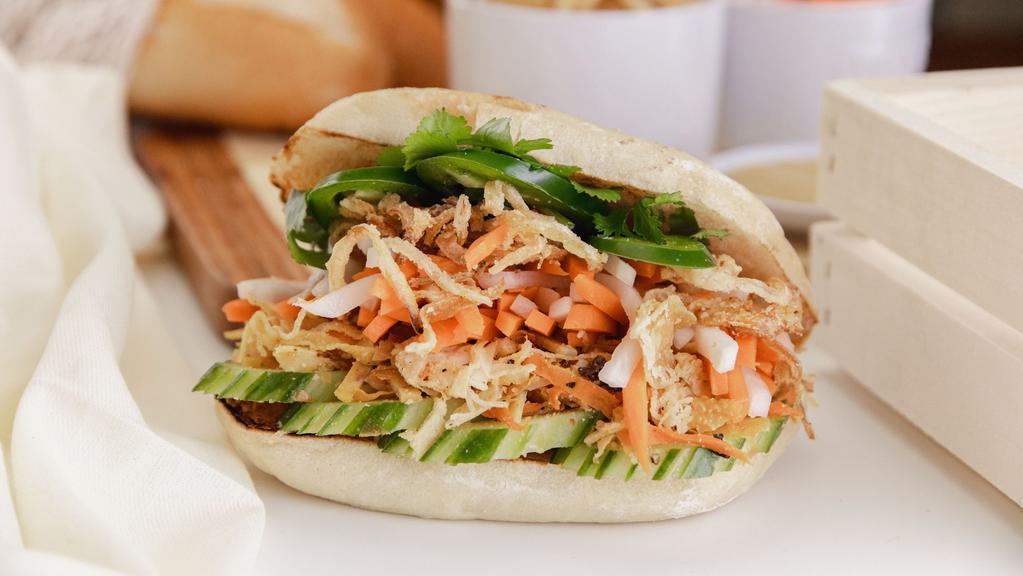 Vegan Banh Mi · Bánh Mì Ô Vuông Bì Chay: Mixed shredded tofu, yams, taro, mushrooms, carrots, jicama with crispy fried onions, cucumbers, sweet pickled carrots & Daikons, cilantro, jalapeños, & Mommy's signature vegan cilantro sauce in a soft ciabatta bread
