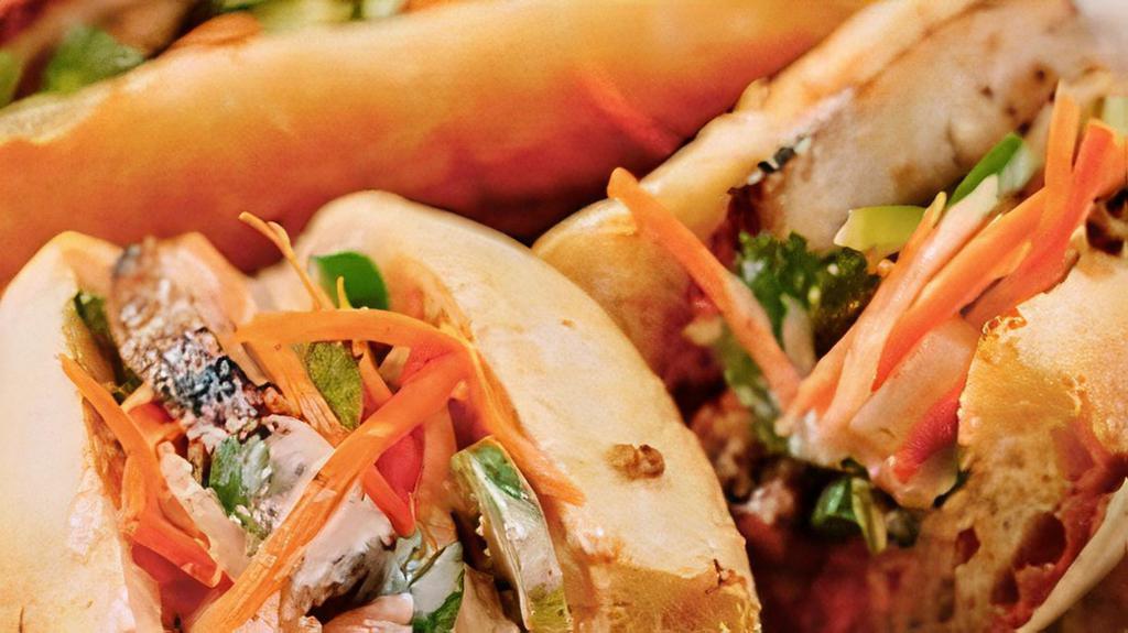 BBQ Lemongrass Chicken Banh Mi · Baguette Bánh mì Ga nướng: BBQ chicken lemongrass chicken thigh, crispy fried onions, sweet pickled carrots & daikons, cucumbers, cilantro, Mommy's Signature Sauce, chicken pate, jalapeños in a fresh baguette