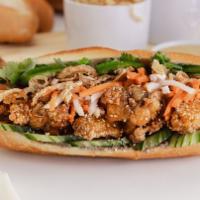 Fried Chicken Banh Mi · Baguette Bánh Mi: Fried chicken glazed with our signature sweet and savory fish sauce, crisp...