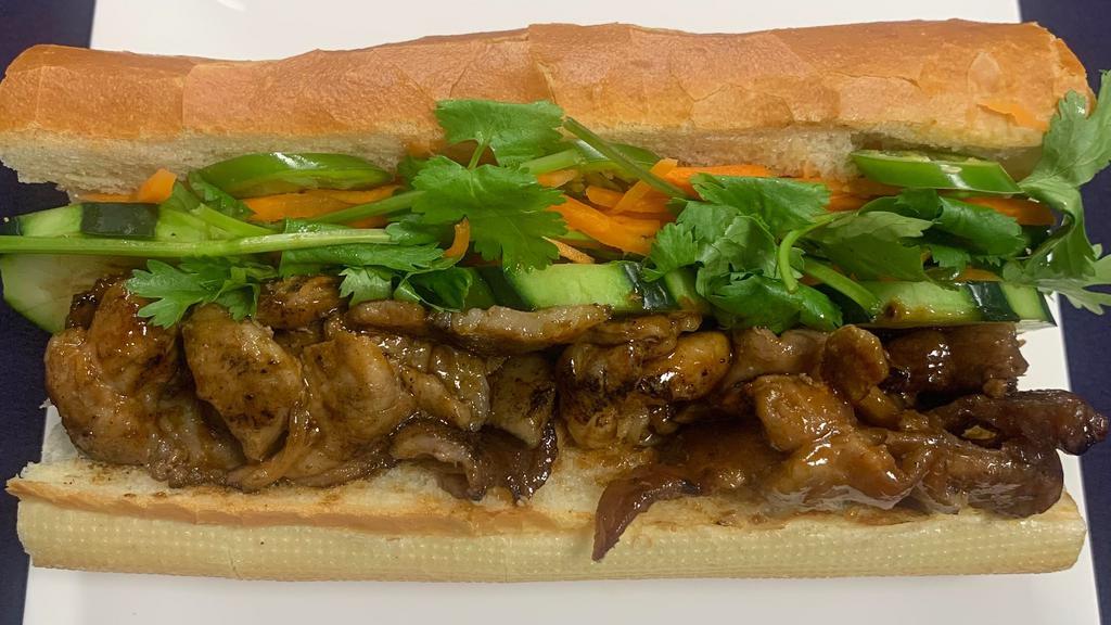 Grilled Pork Banh Mi · Grilled pork, pickled carrot, cilantro, scallion, jalapeños, chilli paste, mayonnaise, and soy sauce.