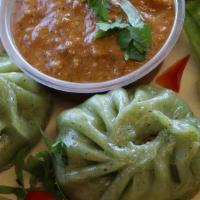 Veggie Momo  · Vegetarian. Famous Nepalese style steamed veggie dumpling served with tomato & sesame chutney.