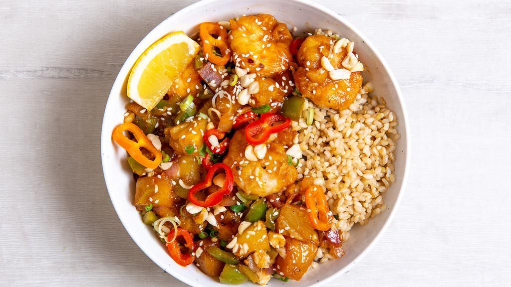 Hollywood Sweet And Sour Tofu · Sesame tofu with chili-dusted pineapple, peppers & onions, roasted salt-free peanuts, green onions, sesame seeds, and our house-made sweet and sour sauce.  Served with a lemon wedge, and a base of your choice. (gluten-free)