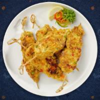 Chicken Skewered Satay · Grilled skewered chicken marinated with Thai herbs and spices, served with peanut sauce and ...