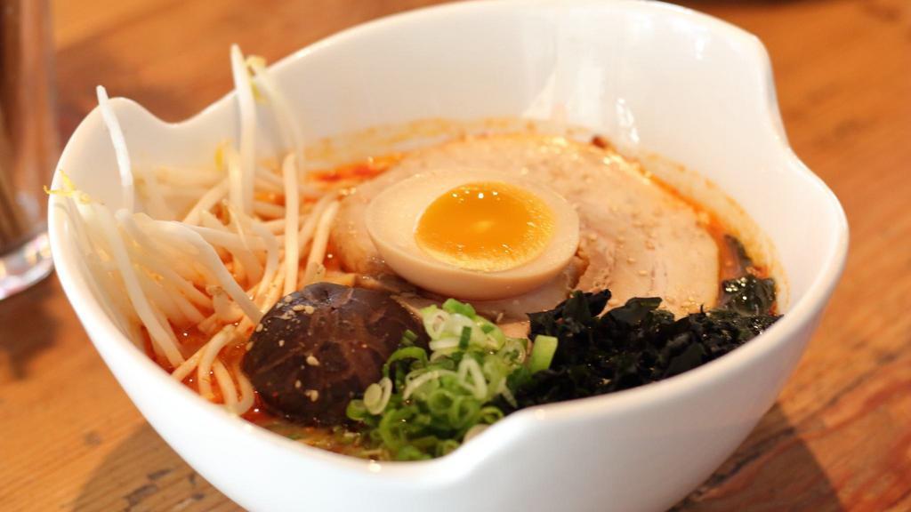 Spicy Miso Ramen · Topped with chashu, soft boiled egg, shiitake mushroom, seaweed, green onion, and sesame seeds in spicy miso broth. Option available for vegetarian.