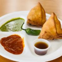 Samosas (2) · Two deep fried pastries filled with spiced potatoes