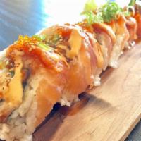 Juicy Roll · Imitation Crab, avocado, eel, cucumber topped with salmon, yellowtail, spicy tuna, sesame se...