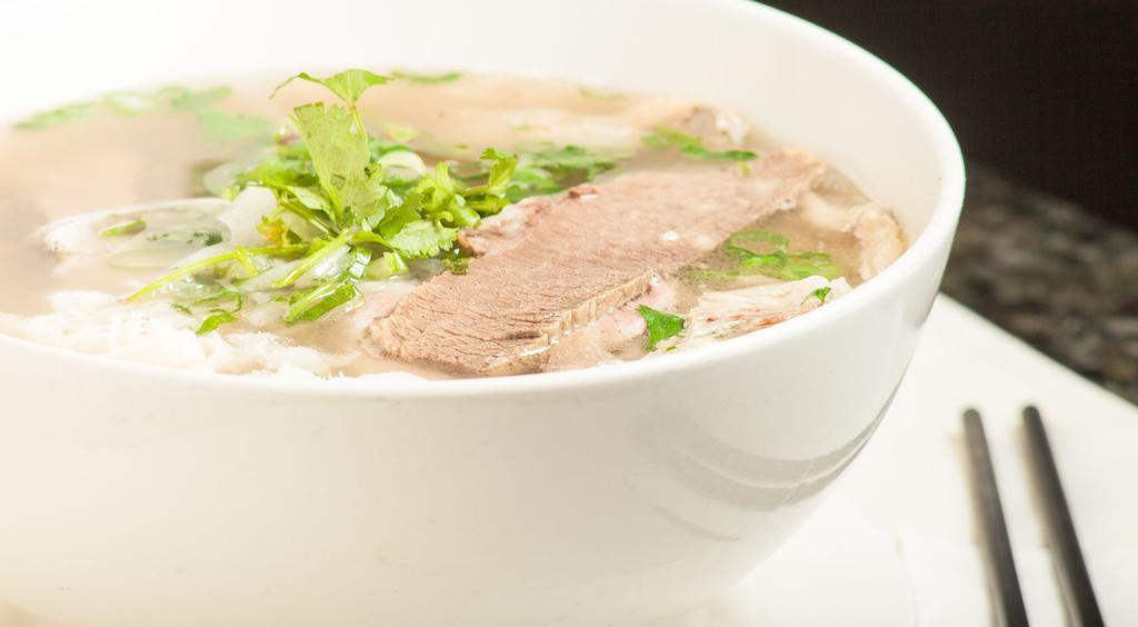1. Phó Đặc Biệt (House Special Pho) · Rice noodles with rare sliced eye round steak, well done brisket and flanks, tendon, and tripe in a beef stock.