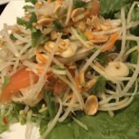 Green Papaya Salad (Som-Tum) · Shredded green papaya with green bean, carrot, tomatoes and peanuts, tossed with spicy lime ...