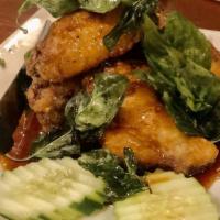 Crispy Thai Basil Chicken Wings · Crispy chicken wings topped with Thai Basil served with a spicy tamarind sauce
