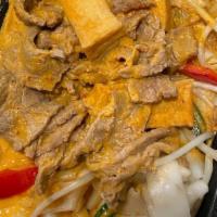 Coconut Pad Thai · Pan-fried rice noodles topped with sautéed choice of meat (chicken, pork, or veggie), fried ...
