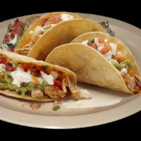 CRISPY TACOS · Vegetarian. Three crispy corn tortillas  filled with meat, re fried beans, lettuce, sour cre...
