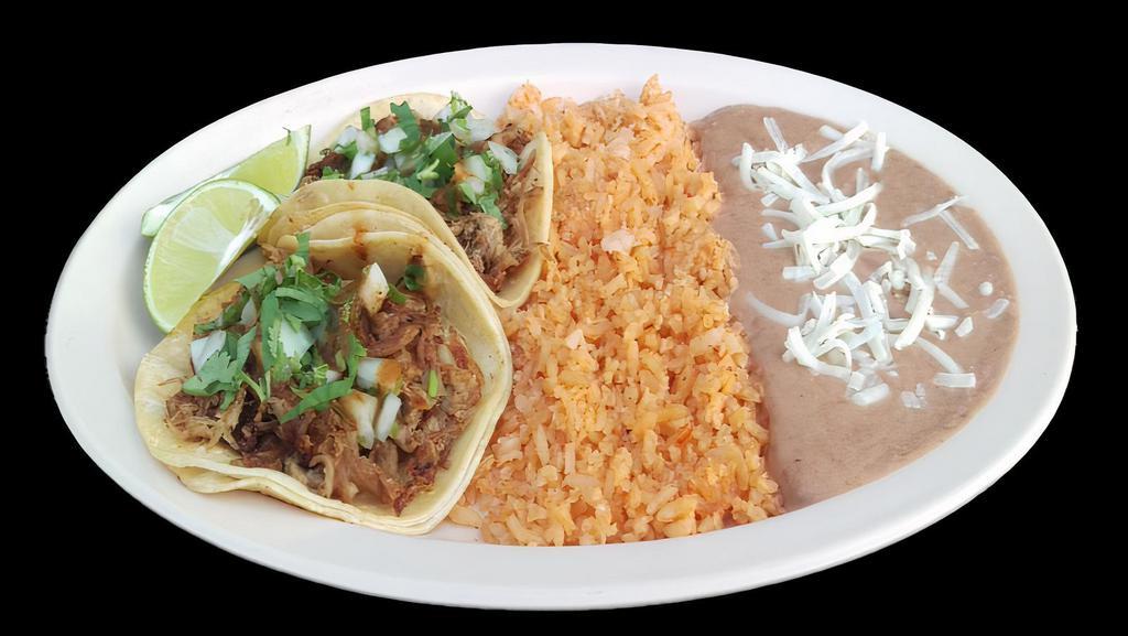 TACO COMBO · Two tacos with meat, onions, cilantro, and salsa served with an order of rice and refried beans topped with cheese