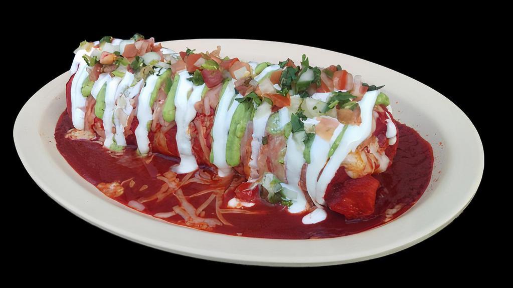 WET BURRITO · Vegetarian. Wet burrito with meat, beans, rice, topped with a thick red sauce, melted cheese, sour cream, guacamole, and salsa.