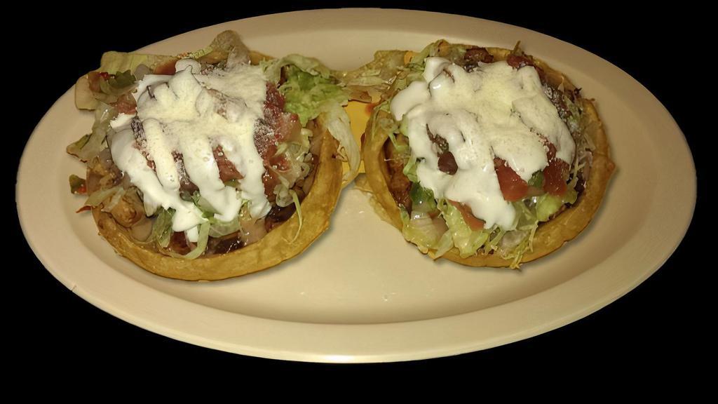 SOPES 2pcs · Vegetarian. Two thick corn masa tortillas topped with meat, refried beans, lettuce, sour cream, cheese, and salsa.