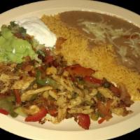 FAJITAS PLATE · Vegetarian. Grilled with bell peppers, onions, and tomatoes.  Served with rice, refried bean...
