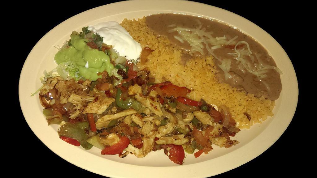 FAJITAS PLATE · Vegetarian. Grilled with bell peppers, onions, and tomatoes.  Served with rice, refried beans topped with cheese, lettuce, sour cream, guacamole, salsa and corn tortillas.