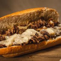 The Philly Cheesesteak · thinly sliced rib eye on a hoagie roll topped with grilled onions and melted provolone cheese.