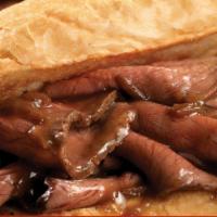 The Hot Roast Beef · thinly sliced hot roast beef on a hoagie roll, topped with American cheese, onions, and our ...