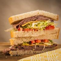 The Roast Beef · sliced roast beef topped with swiss cheese, shredded lettuce, tomatoes and brown mustard.