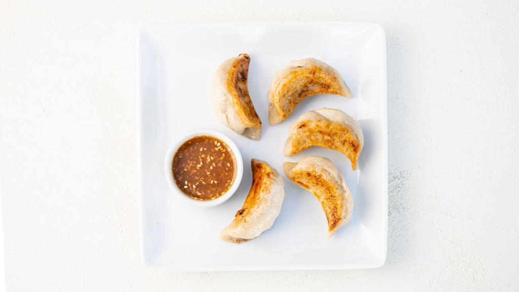 The Sweet Potato Potsticker · Pan-seared, gluten-free potstickers filled with roasted sweet potato, fresh garlic, and fresh ginger. Served with our house-made ginger garlic sauce. 5 per order. (gluten-free & vegan)