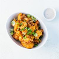 Kung Pao Cauliflower Wings · Crispy gluten-free cauliflower wings tossed in Kung Pao sauce and served with housemade vega...