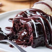 Triple Chocolate Meltdown® · Warm, rich, fudge-filled chocolate cake is drizzled with hot fudge. Served with vanilla ice ...