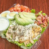 Cobb salad · Chicken breast, bacon, avocado, crumbled blue cheese and tomatoes on a fresh bed of lettuce ...