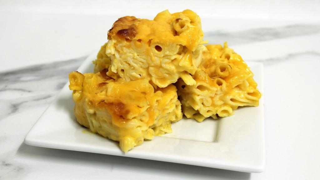 Macaroni and Cheese · Creamy elbow macaroni coated in a rich, velvety cheddar cheese sauce. Served cold in a microwavable container. Reheating required.