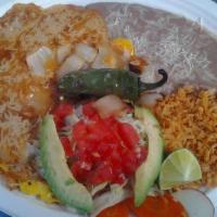 Huevos Ranchero · two sunny side huevos on top of 2 tortillas, rice and beans, lettuce, tomato, avocado, and s...