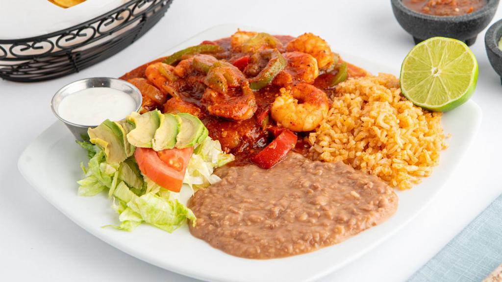 Camarones a la Diabla · Sautéed shrimp covered in a red sauce served with rice, beans, lettuce, tomato, sour cream & tortillas.