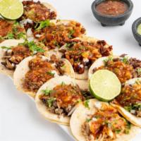 Tacos de Pescado · 2 grilled fish tacos on a corn tortilla with lettuce and pico de gallo.