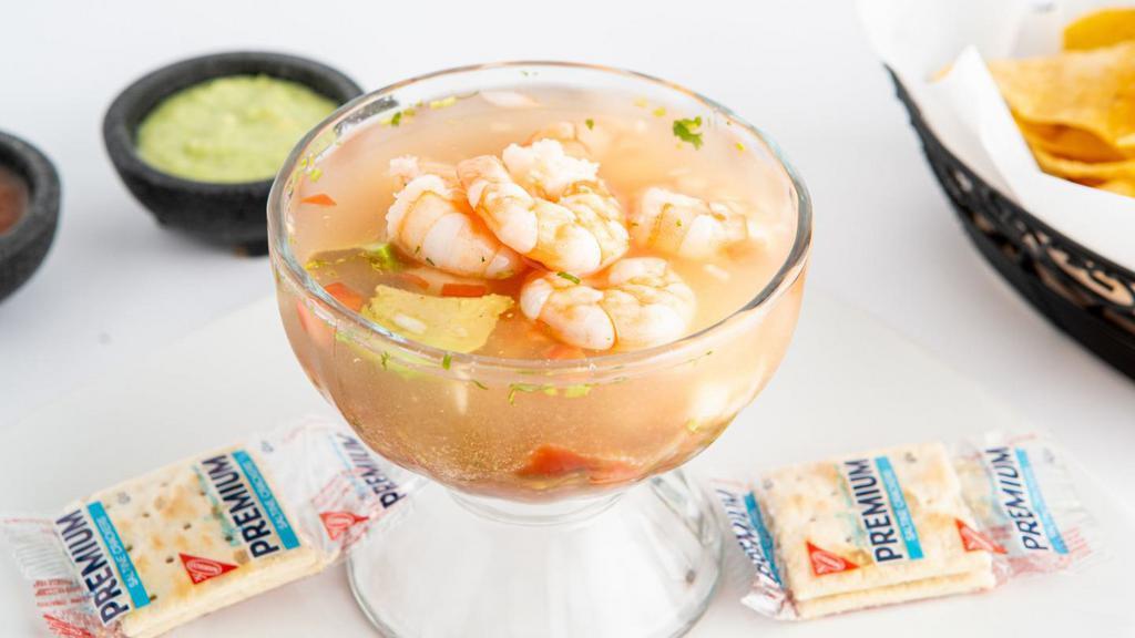 Coctel de Camaron · Shrimp cocktail chilled in tomato juice cocktail with ketchup, avocado, onion and cilantro.