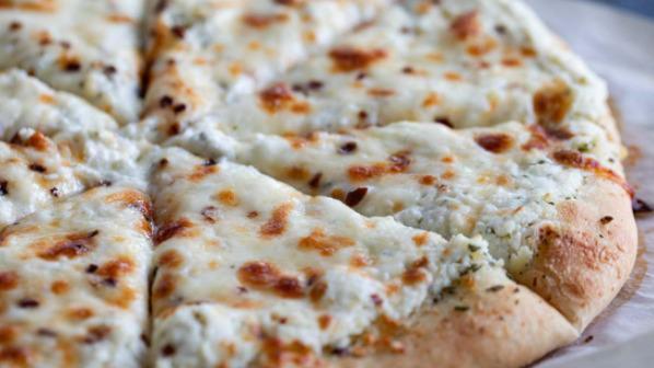 White Pizza (Medium) · Pizza with cream ricotta, mozzarella, roasted garlic, basil with white sauce.