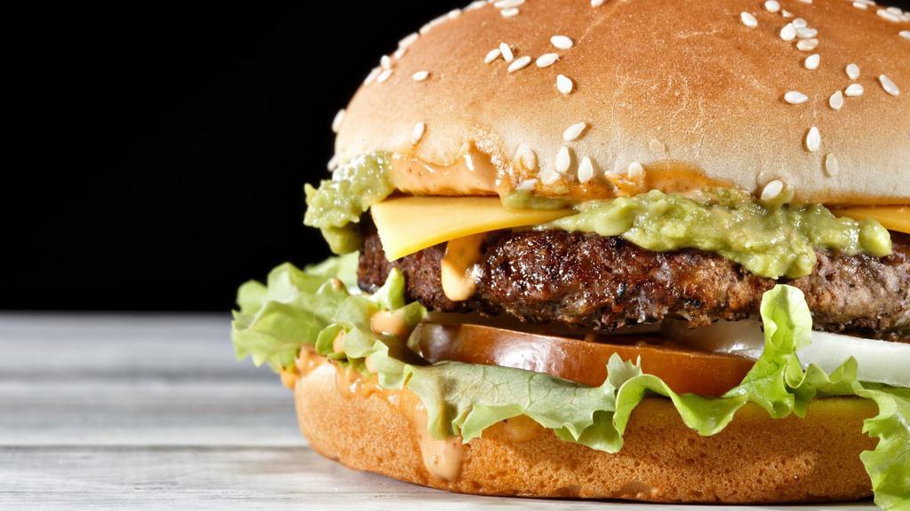 The Avocado Cheeseburger · Sizzling beef patty topped on with melted cheese, fresh avocado, lettuce, tomatoes, pickles, onions, ketchup and mustard on a sesame seed bun.
