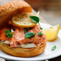 Tasty Salmon Burger · Sizzling salmon patty topped on with melted cheese, lettuce, tomatoes, pickles, onions, ketc...