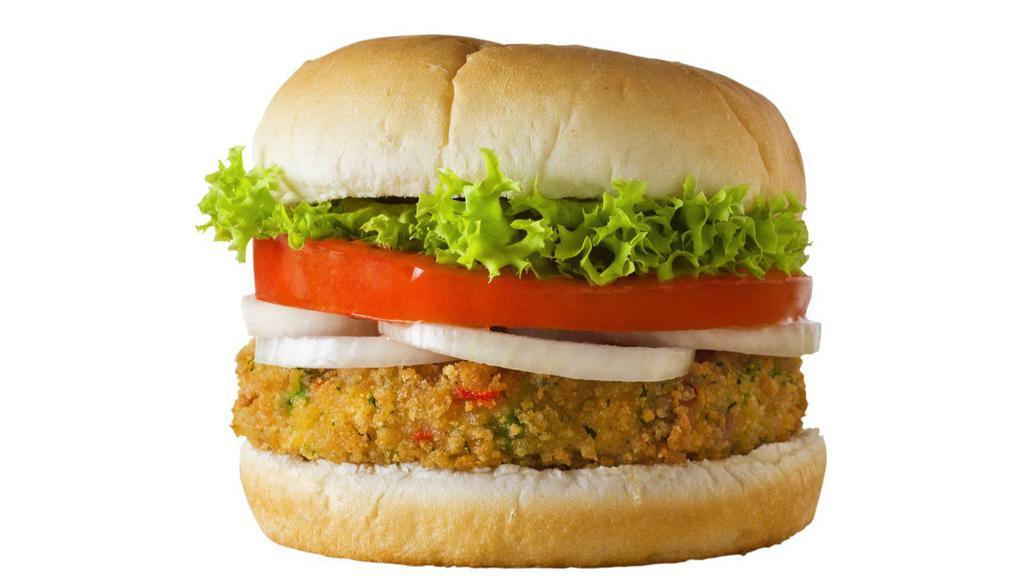 The Veggie Burger · Grilled veggie patty topped on with melted cheese, lettuce, tomatoes, pickles, onions, ketchup and mustard on a sesame seed bun.