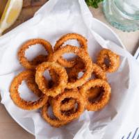 Onion Rings · Whole white onions cut and battered with a subtle blend of spices.