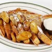 Bananas Foster French Toast · Our classic french toast smothered in warm butter-rum sauce with caramelized bananas and whi...
