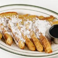 French Toast · Three thick slices of cinnamon-battered egg bread.
