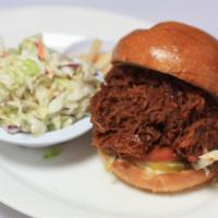 Pulled Pork sandwich · Barbecue sauce, lettuce, tomatoes, mayo & dill pickles on a toasted bun. Choice cole slaw or...